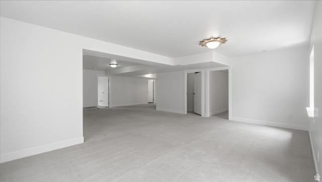 2038 East Ranch Road Eagle Mountain, UT 84005 - Photo 37 of 66 Spacious room featuring light gray carpeting, white walls, white trim, and recessed lighting