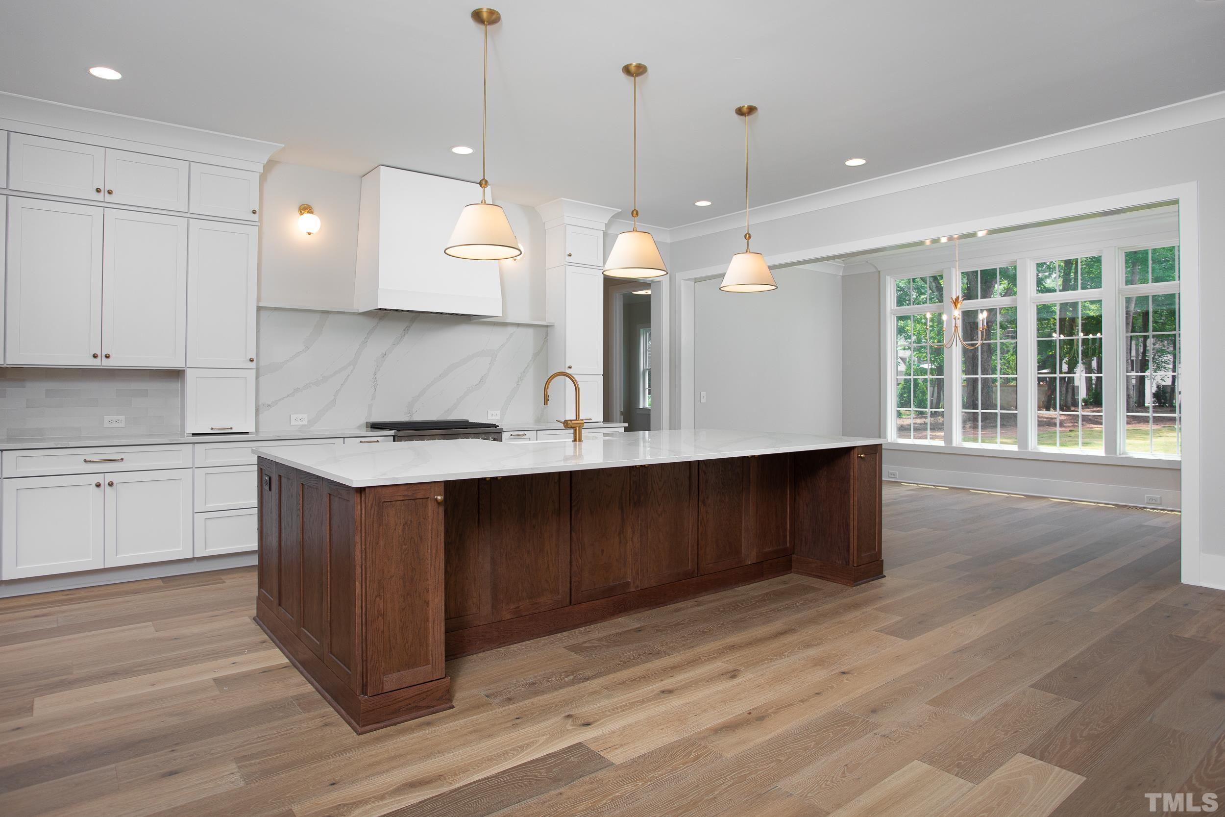 1501 Starry Night Court Raleigh, NC 27613 - Photo 10 of 47 a kitchen with a sink cabinets and wooden floor