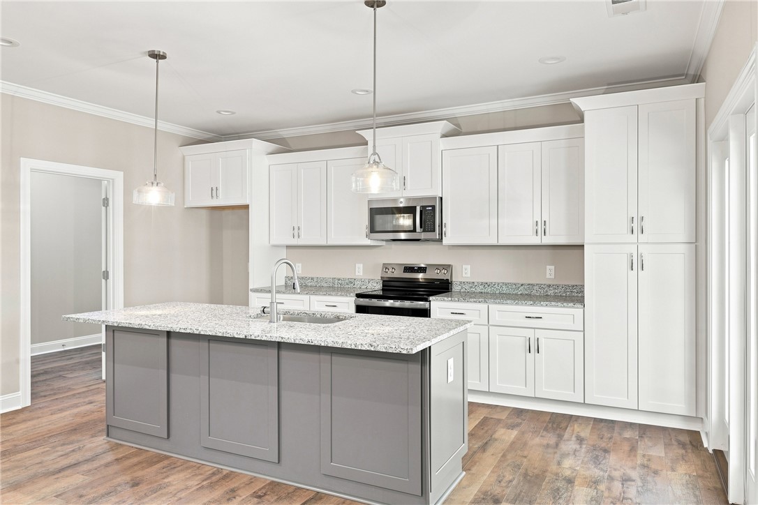 216 West Halfway Branch Road Walhalla, SC 29691 - Photo 11 of 41 Gleaming stone countertops and a contrasting island anchor this contemporary kitchen workspace.