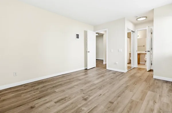 a view of an empty room and wooden floor