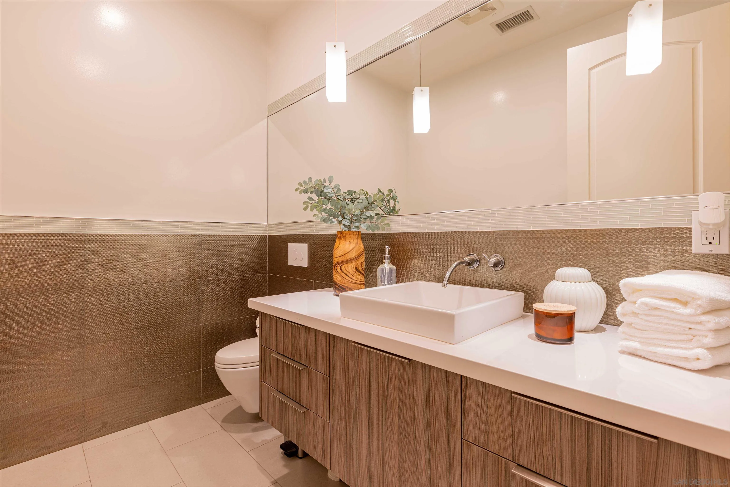 17676 Vista Rancho Court Rancho Santa Fe, CA 92091 - Photo 53 of 71 a bathroom with a sink a toilet and mirror