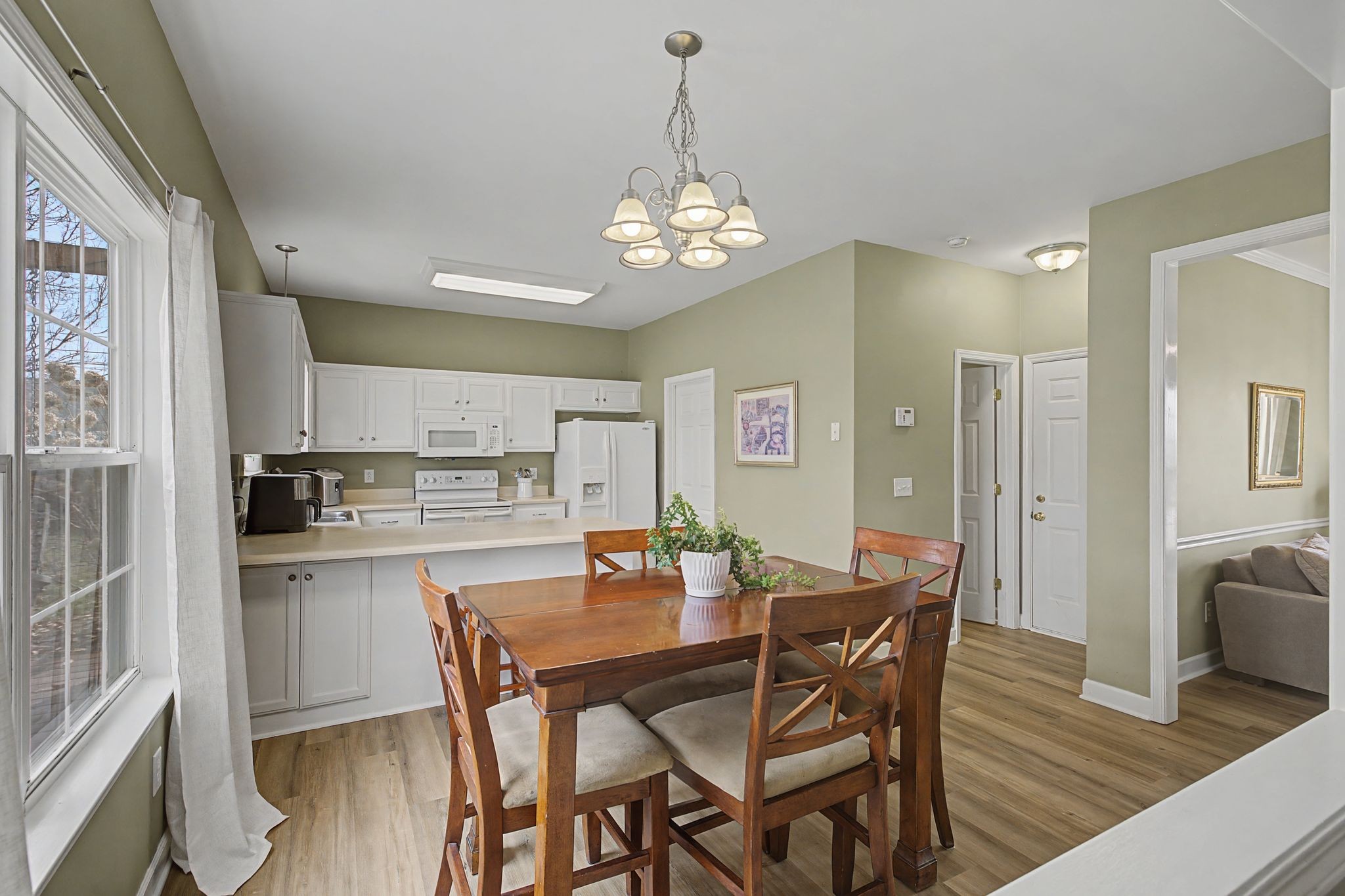 4012 Farmville Court Spring Hill, TN 37174 - Photo 12 of 29 a view of a dining room with furniture wooden floor and a chandelier