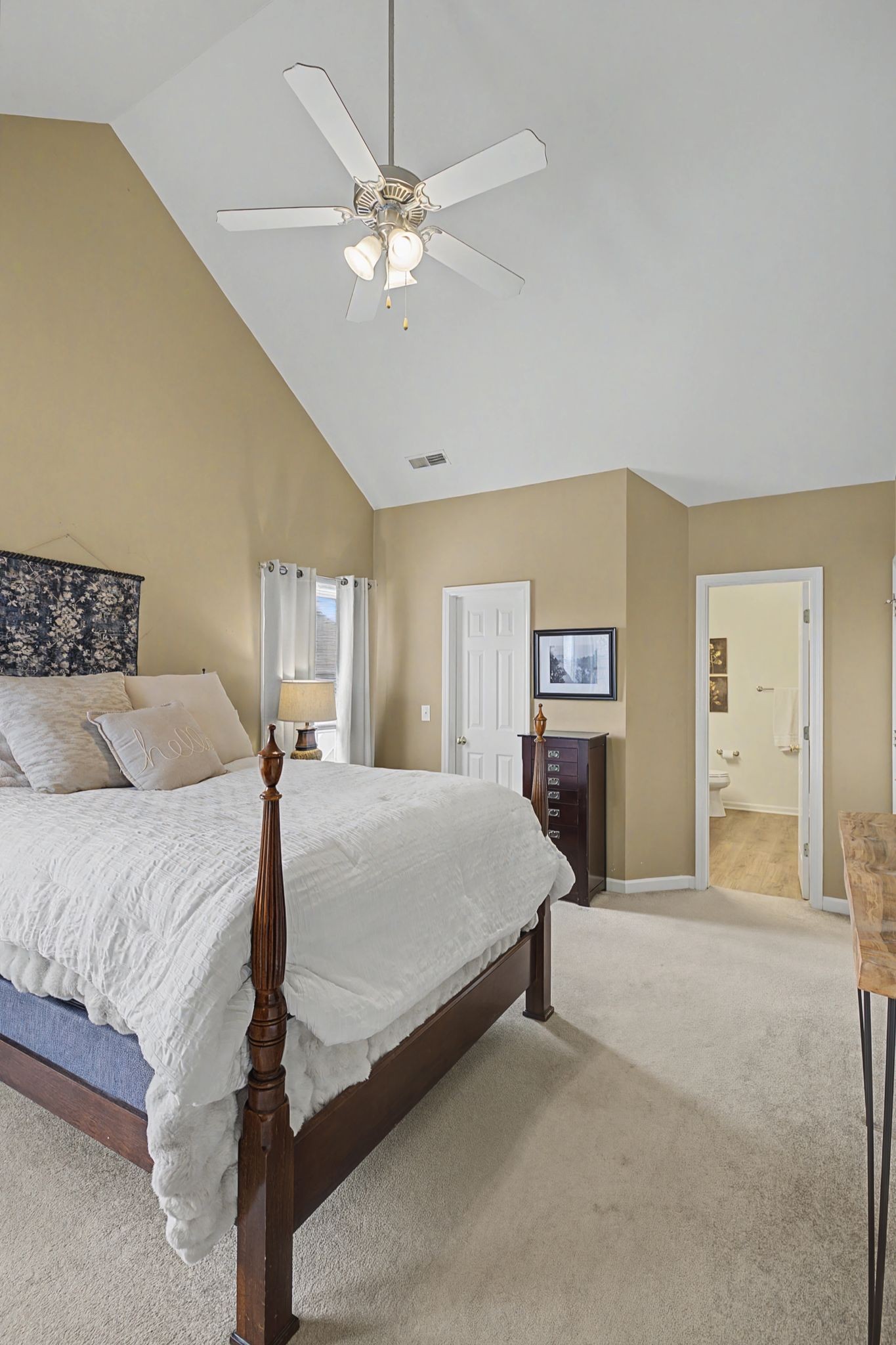 4012 Farmville Court Spring Hill, TN 37174 - Photo 19 of 29 a spacious bedroom with a large bed and a chandelier