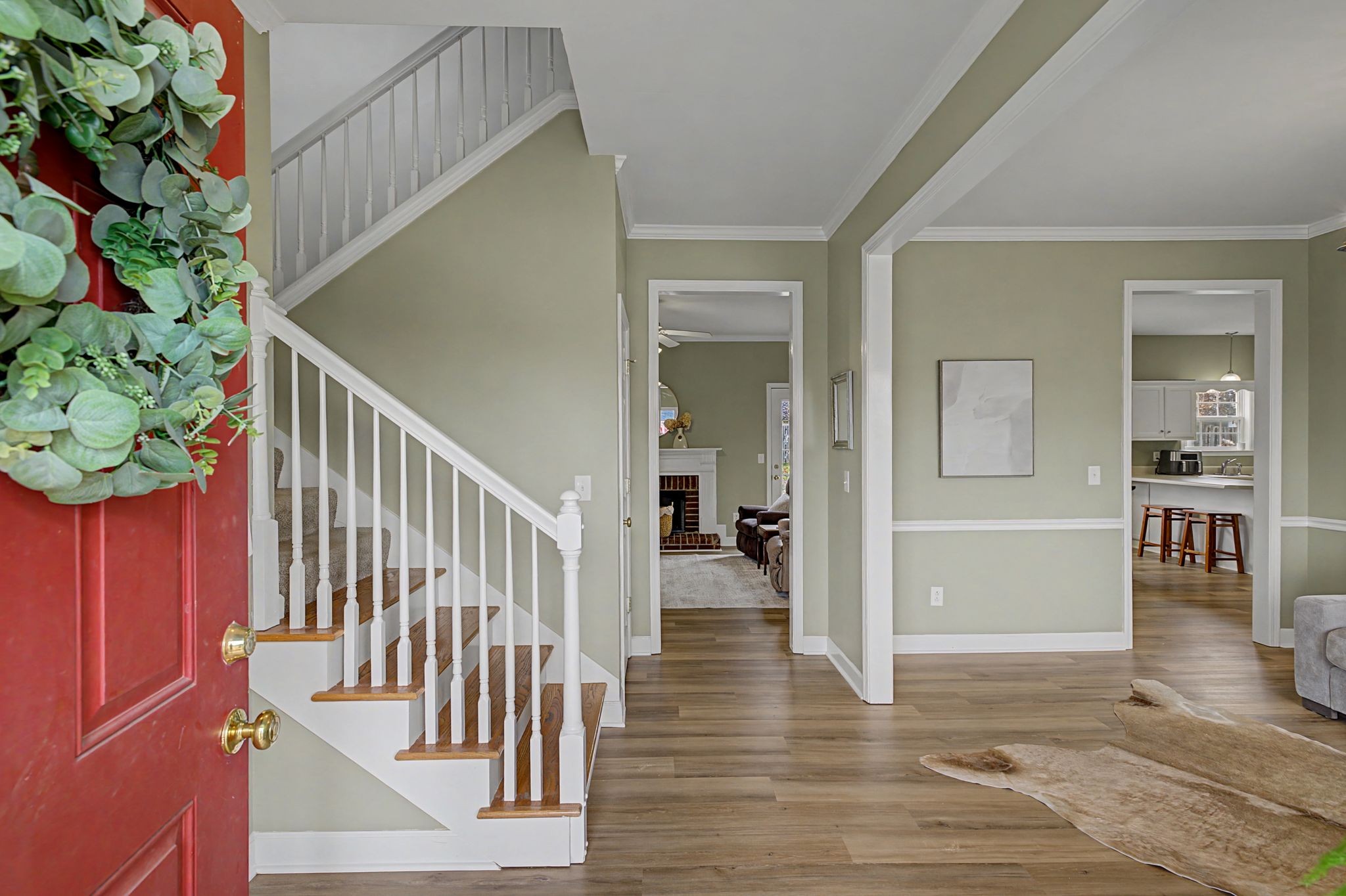 4012 Farmville Court Spring Hill, TN 37174 - Photo 4 of 29 a view of a hallway with wooden floor and a potted plant