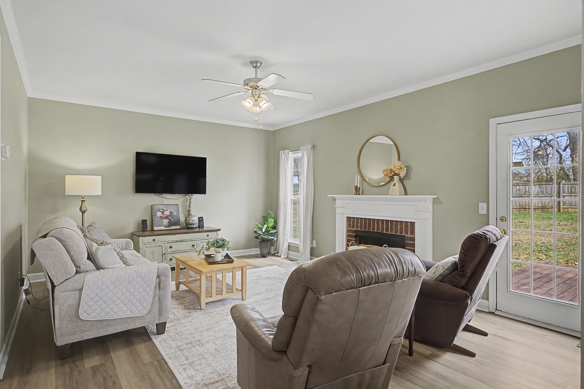 4012 Farmville Court Spring Hill, TN 37174 - Photo 9 of 29 a living room with furniture a fireplace and a flat screen tv