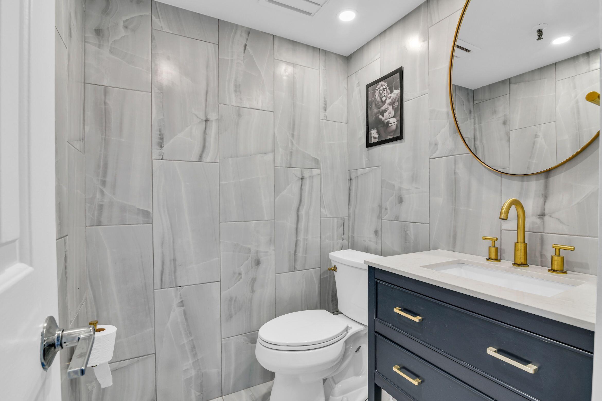 859 Jeffery Street, Unit 5090 Boca Raton, FL 33487 - Photo 17 of 55 a bathroom with a toilet sink and mirror