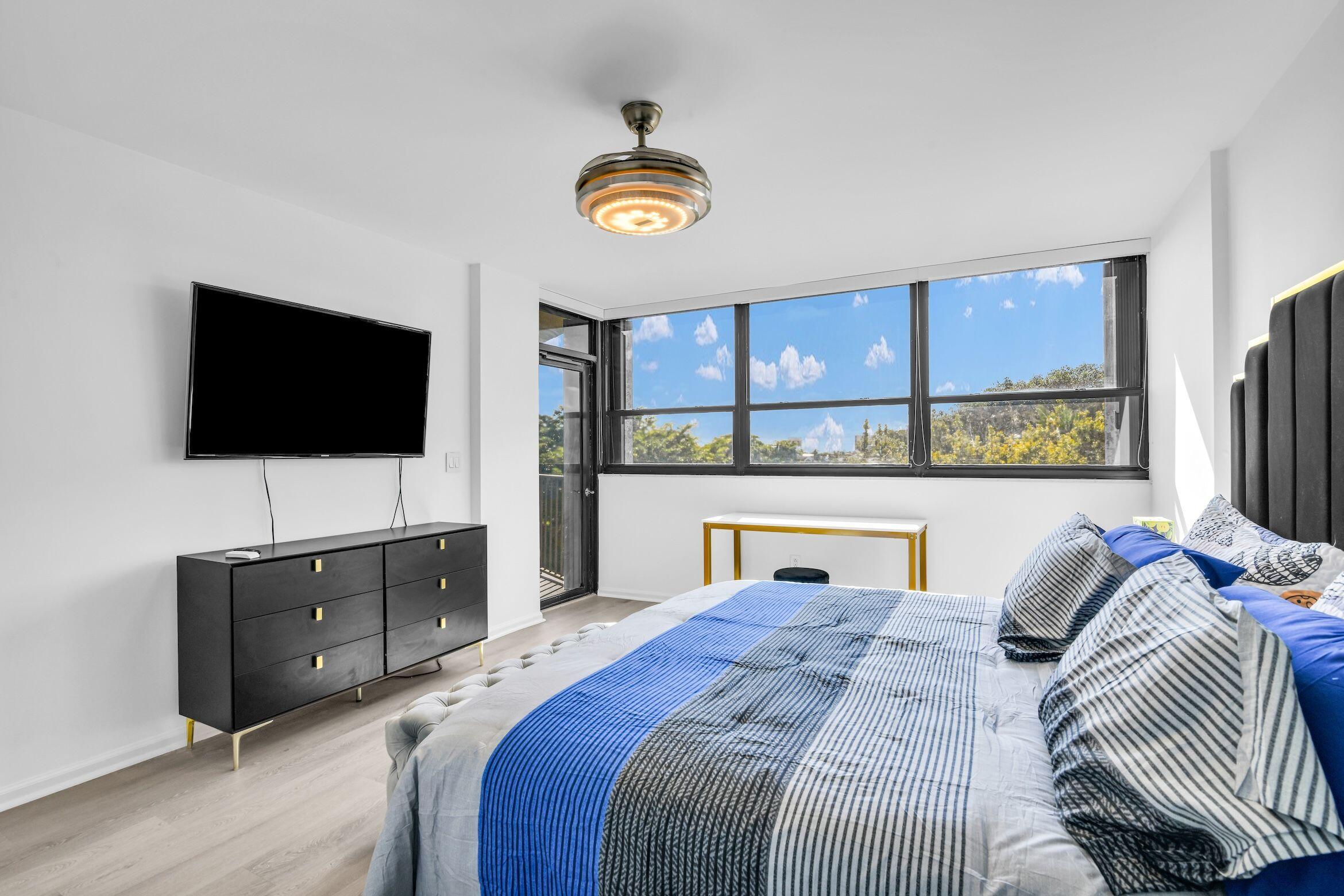 859 Jeffery Street, Unit 5090 Boca Raton, FL 33487 - Photo 23 of 55 a bedroom with a bed and a flat screen tv