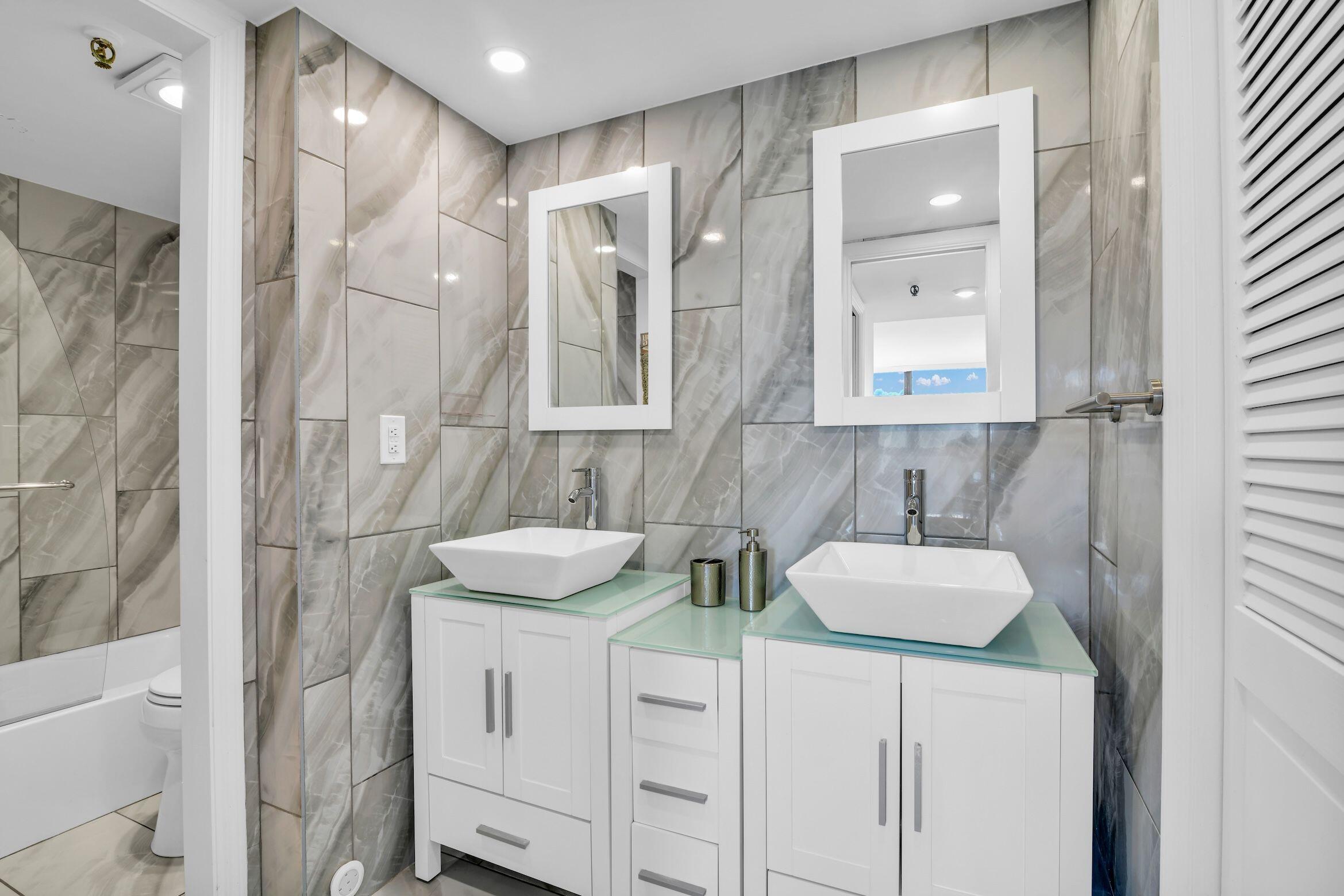 859 Jeffery Street, Unit 5090 Boca Raton, FL 33487 - Photo 25 of 55 a bathroom with double vanity sink and two mirror