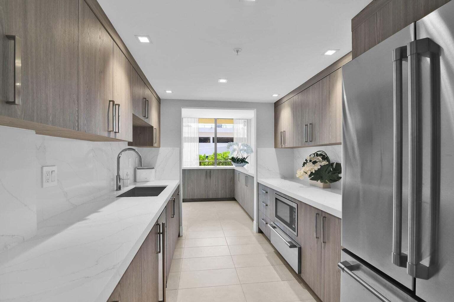 859 Jeffery Street, Unit 5090 Boca Raton, FL 33487 - Photo 55 of 55 a kitchen with a sink and a refrigerator