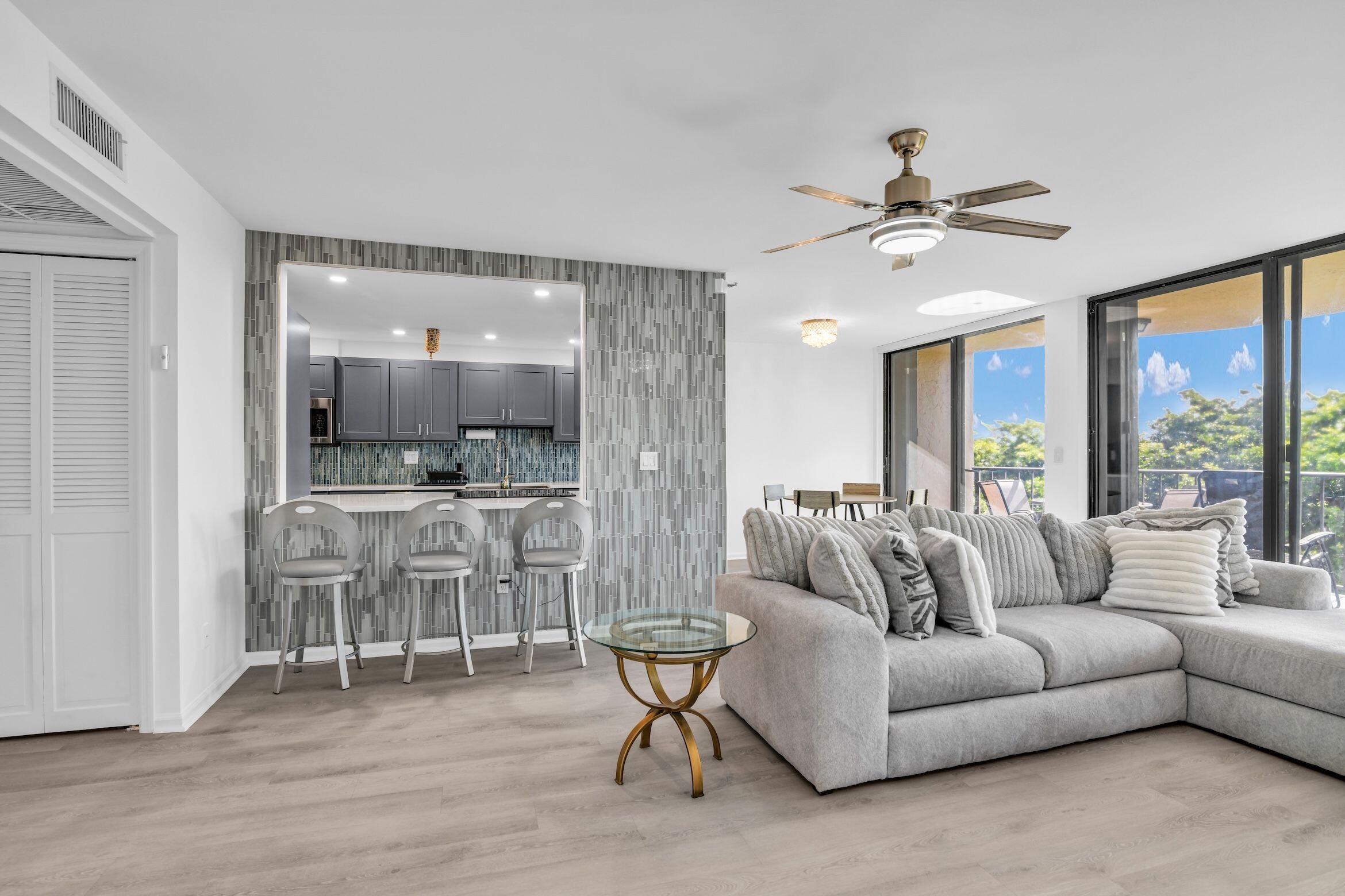 859 Jeffery Street, Unit 5090 Boca Raton, FL 33487 - Photo 8 of 55 a living room with furniture and a large window