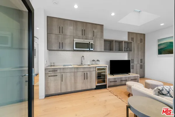 a kitchen with stainless steel appliances kitchen island granite countertop a stove and a microwave