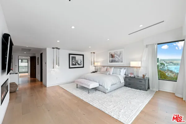 a spacious bedroom with a bed and a couch