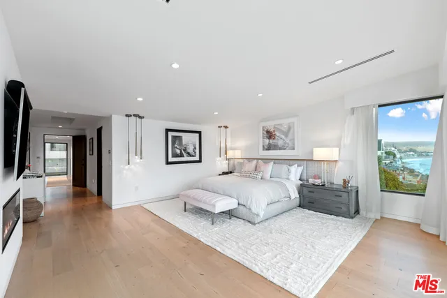 a spacious bedroom with a bed and a couch