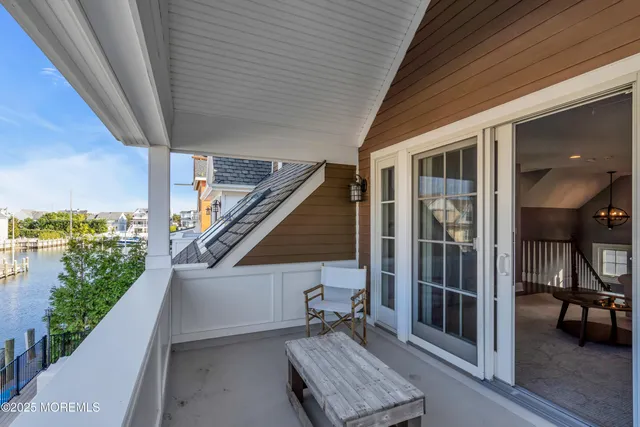 a balcony with furniture and a potted plant