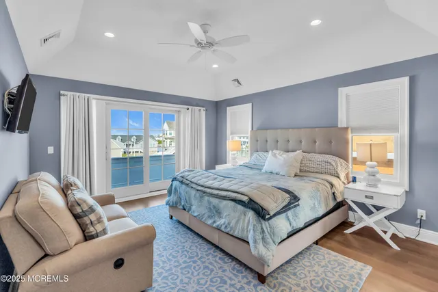 a bedroom with bed couch and window