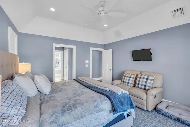 a bedroom with a bed and a couch