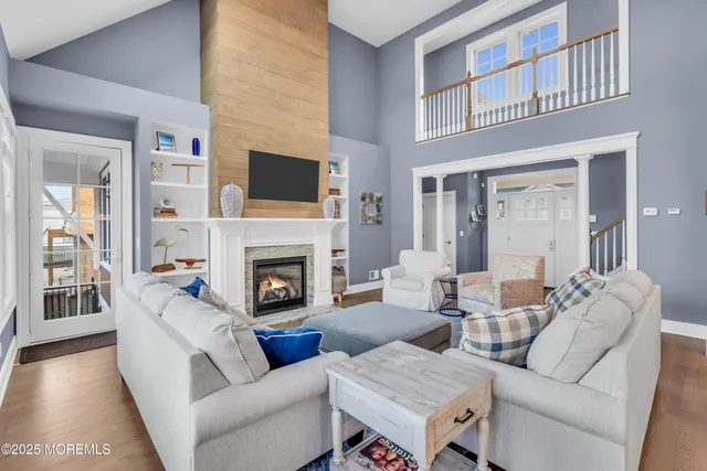 a living room with furniture fireplace and flat screen tv