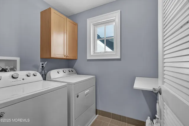 a view of storage and utility room with washer and dryer