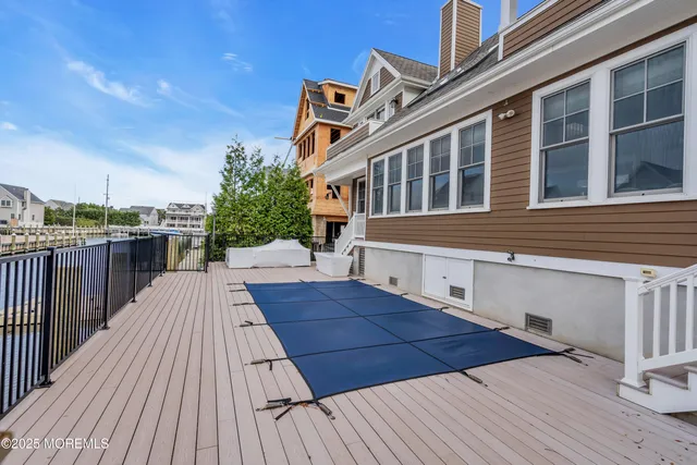 a view of a wooden deck with a yard