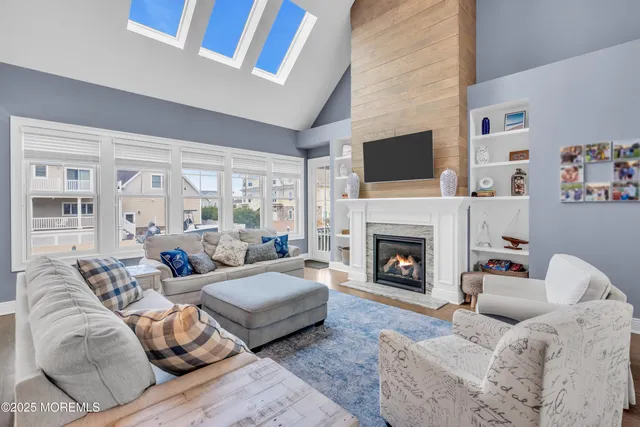 a living room with furniture fireplace and flat screen tv