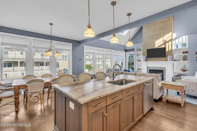 a kitchen with sink and chairs