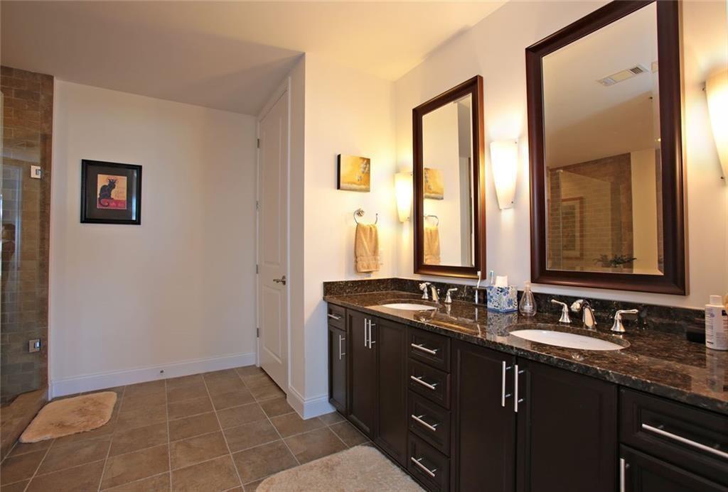 270 17th Street Northwest, Unit 4201 Atlanta, GA 30363 - Photo 13 of 23 a bathroom with a double vanity sink and a mirror