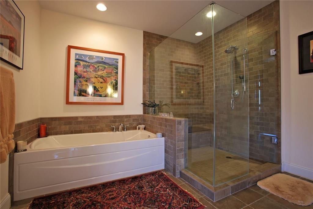 270 17th Street Northwest, Unit 4201 Atlanta, GA 30363 - Photo 14 of 23 a bathroom with a bath tub a shower and a sink