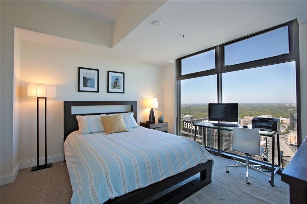 270 17th Street Northwest, Unit 4201 Atlanta, GA 30363 - Photo 15 of 23 a bed room with a bed tv and a window