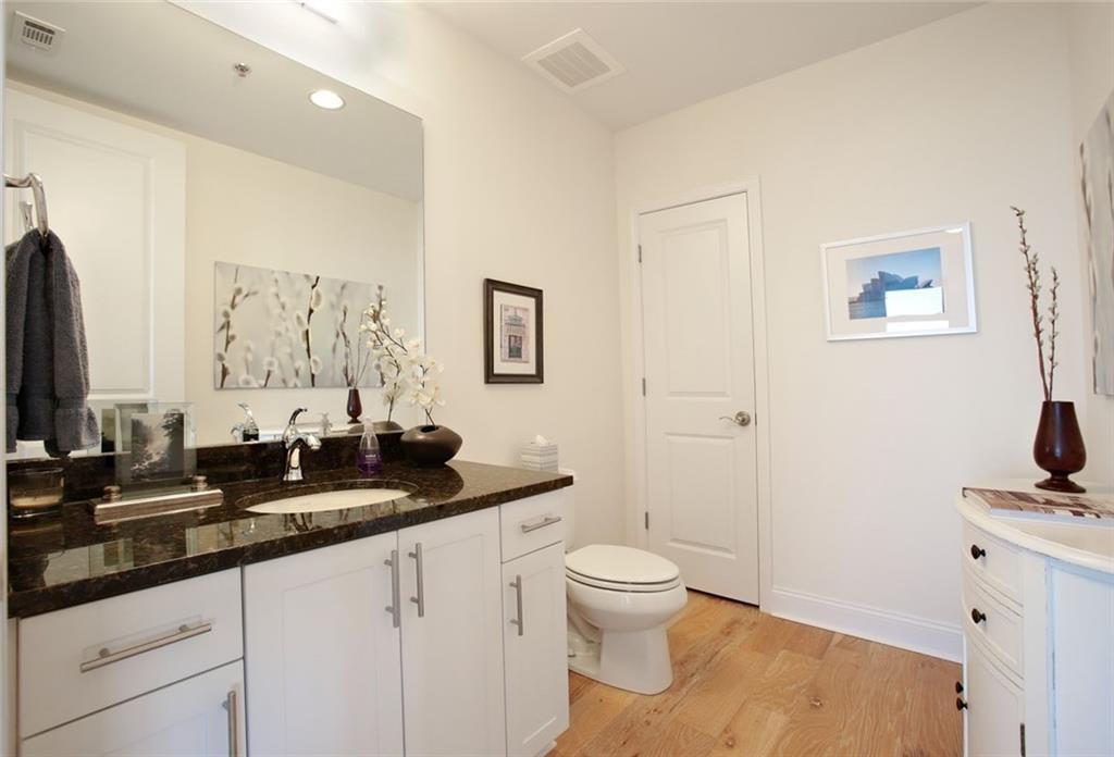 270 17th Street Northwest, Unit 4201 Atlanta, GA 30363 - Photo 18 of 23 a bathroom with a granite countertop sink a toilet and a mirror