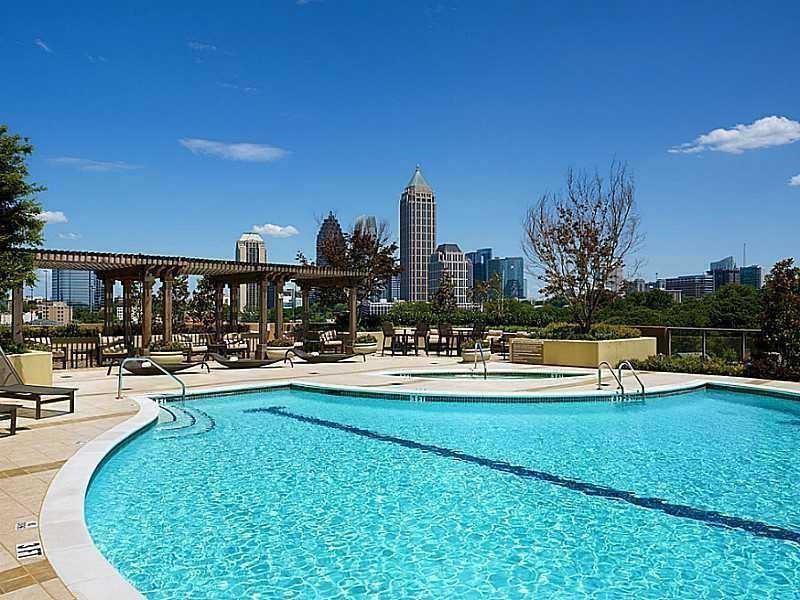 270 17th Street Northwest, Unit 4201 Atlanta, GA 30363 - Photo 21 of 23 a view of a swimming pool and lounge chairs