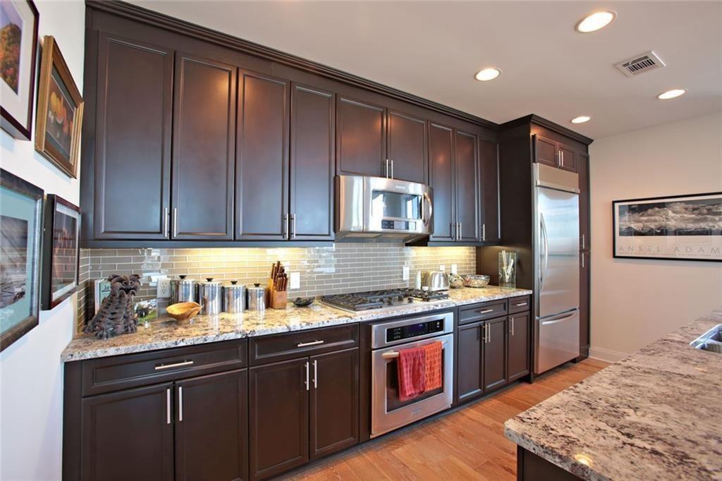 270 17th Street Northwest, Unit 4201 Atlanta, GA 30363 - Photo 6 of 23 a kitchen with stainless steel appliances granite countertop a sink stove and refrigerator