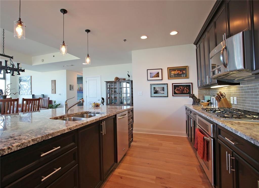 270 17th Street Northwest, Unit 4201 Atlanta, GA 30363 - Photo 7 of 23 a kitchen with stainless steel appliances granite countertop a sink a stove and a wooden floors