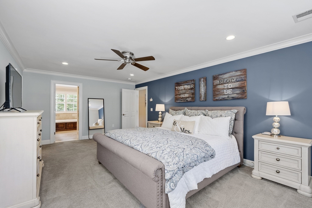 26 Mill Pond Road Bolton, MA 01740 - Photo 19 of 42 a bedroom with a bed and a flat screen tv