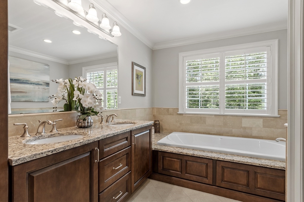 26 Mill Pond Road Bolton, MA 01740 - Photo 20 of 42 a bathroom with a granite countertop bathtub a sink and a window