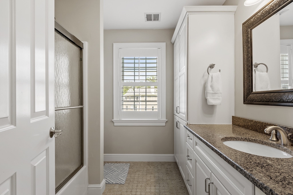 26 Mill Pond Road Bolton, MA 01740 - Photo 26 of 42 a bathroom with a granite countertop sink and a mirror