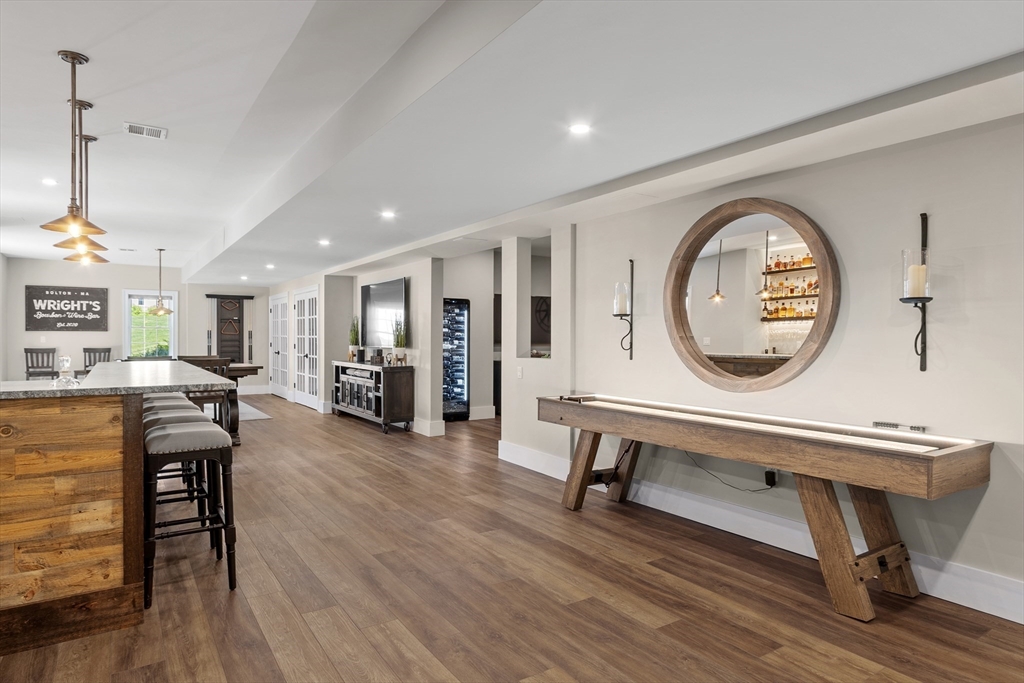 26 Mill Pond Road Bolton, MA 01740 - Photo 29 of 42 a living room with furniture a table and wooden floor