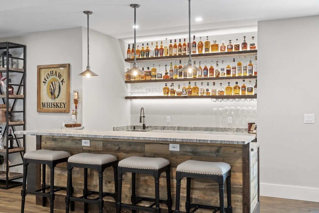 26 Mill Pond Road Bolton, MA 01740 - Photo 30 of 42 a kitchen with a dining table chairs and white cabinets