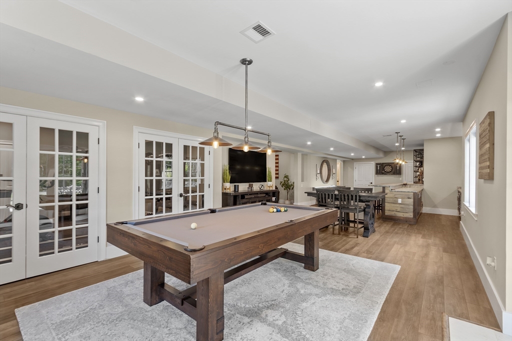 26 Mill Pond Road Bolton, MA 01740 - Photo 31 of 42 a living room with furniture a flat screen tv and a table