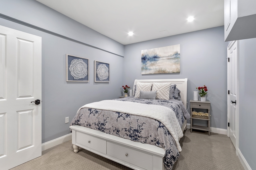 26 Mill Pond Road Bolton, MA 01740 - Photo 33 of 42 a bedroom with a bed and painting on the wall