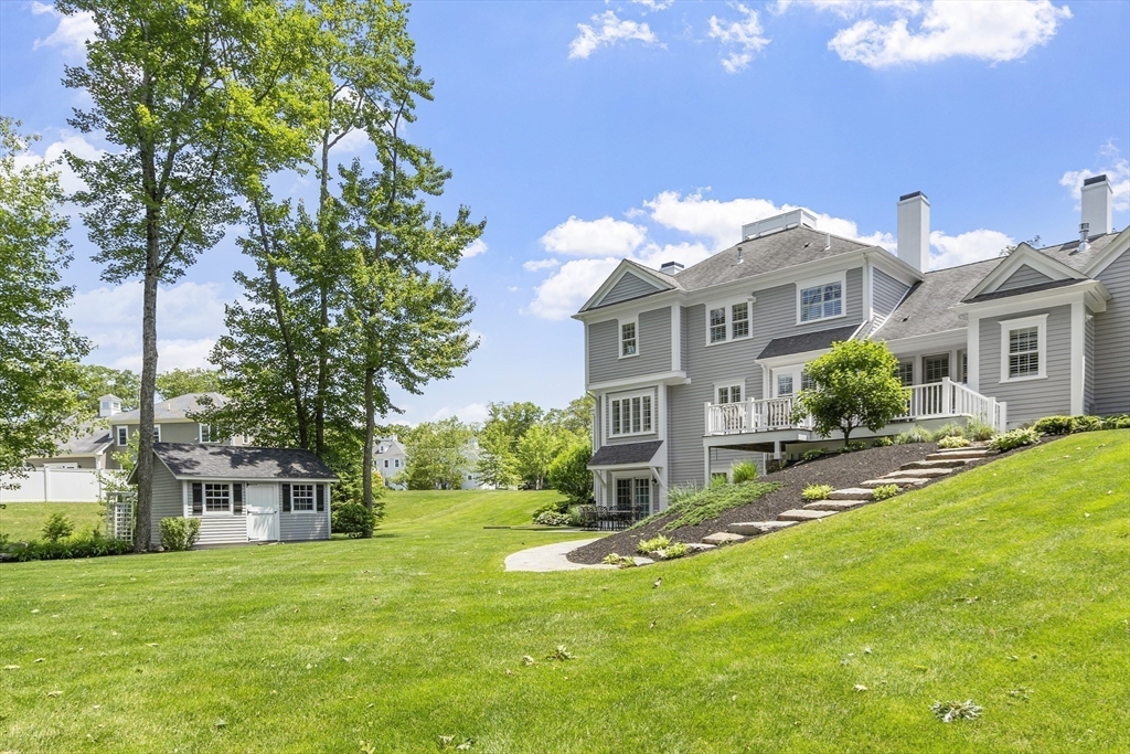 26 Mill Pond Road Bolton, MA 01740 - Photo 38 of 42 a front view of a house with a yard