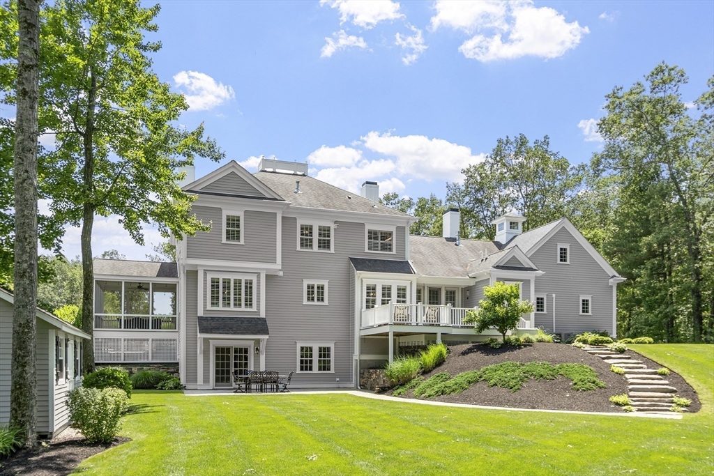 26 Mill Pond Road Bolton, MA 01740 - Photo 39 of 42 a front view of a house with garden