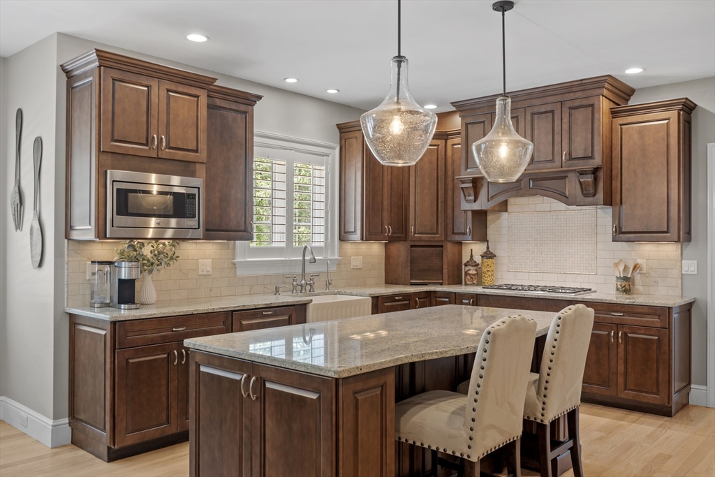26 Mill Pond Road Bolton, MA 01740 - Photo 4 of 42 a kitchen with cabinets a sink stainless steel appliances and dining table
