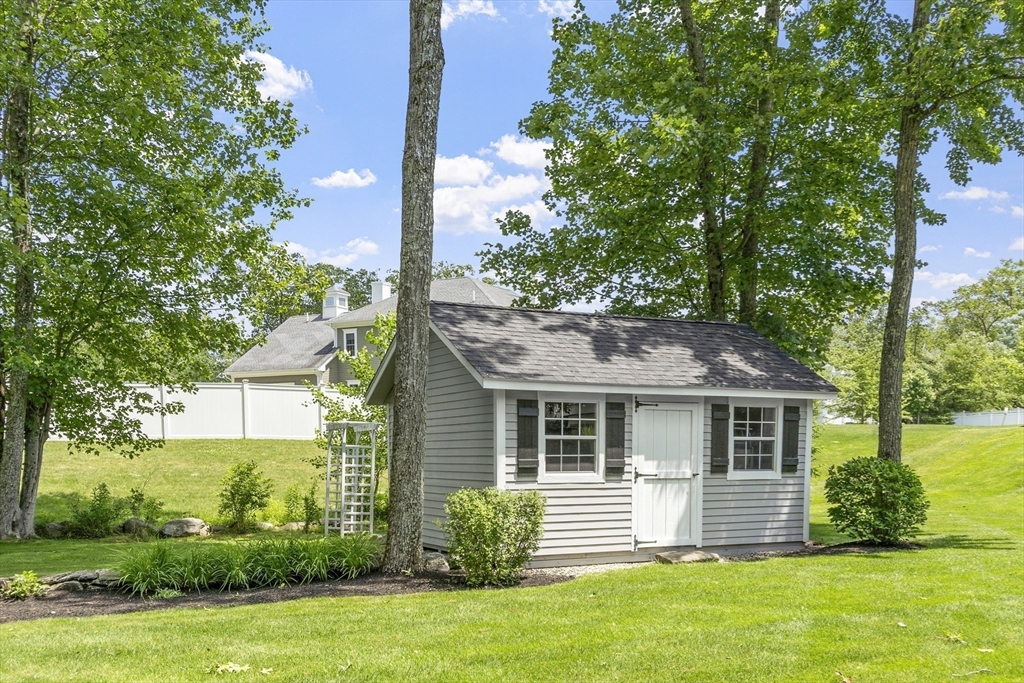 26 Mill Pond Road Bolton, MA 01740 - Photo 41 of 42 a front view of house with yard and green space