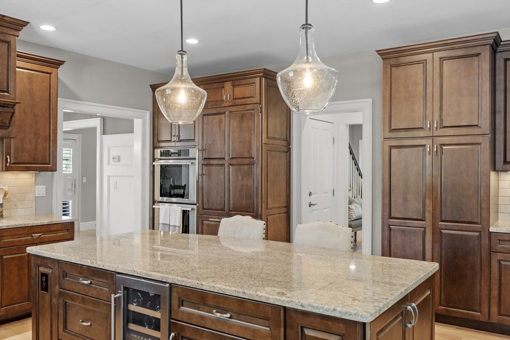 26 Mill Pond Road Bolton, MA 01740 - Photo 5 of 42 a kitchen with stainless steel appliances granite countertop a sink refrigerator and microwave