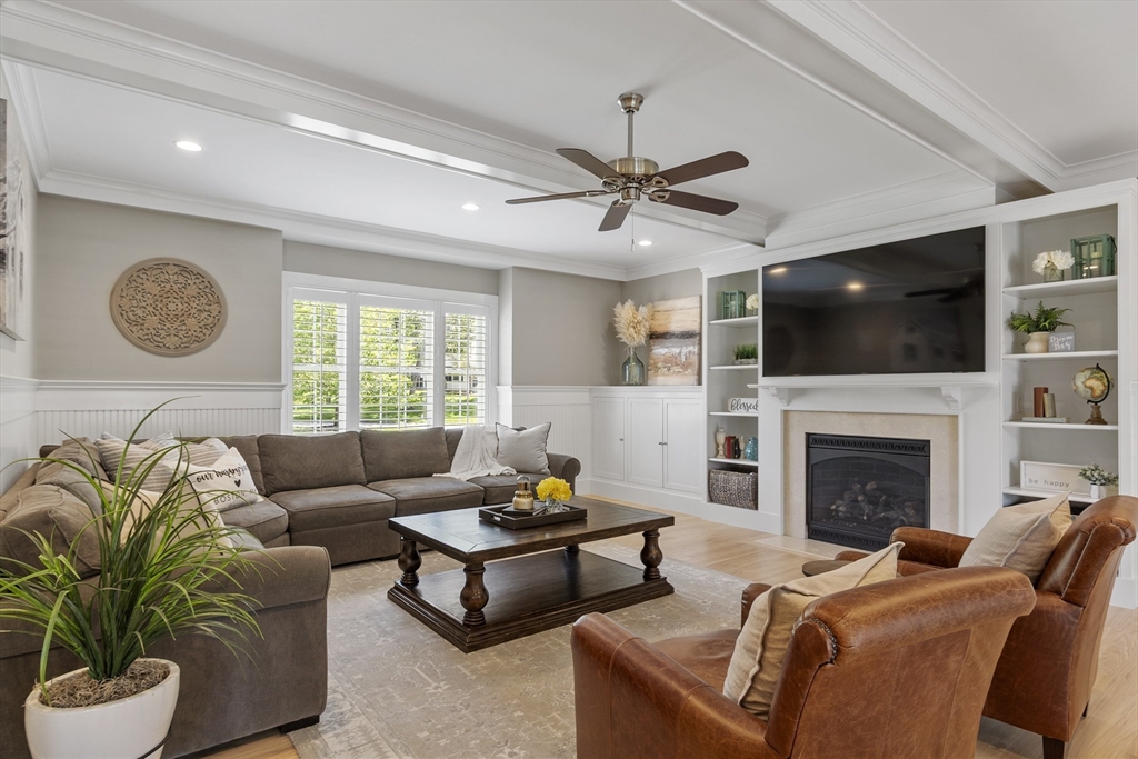26 Mill Pond Road Bolton, MA 01740 - Photo 9 of 42 a living room with furniture a flat screen tv and a fireplace