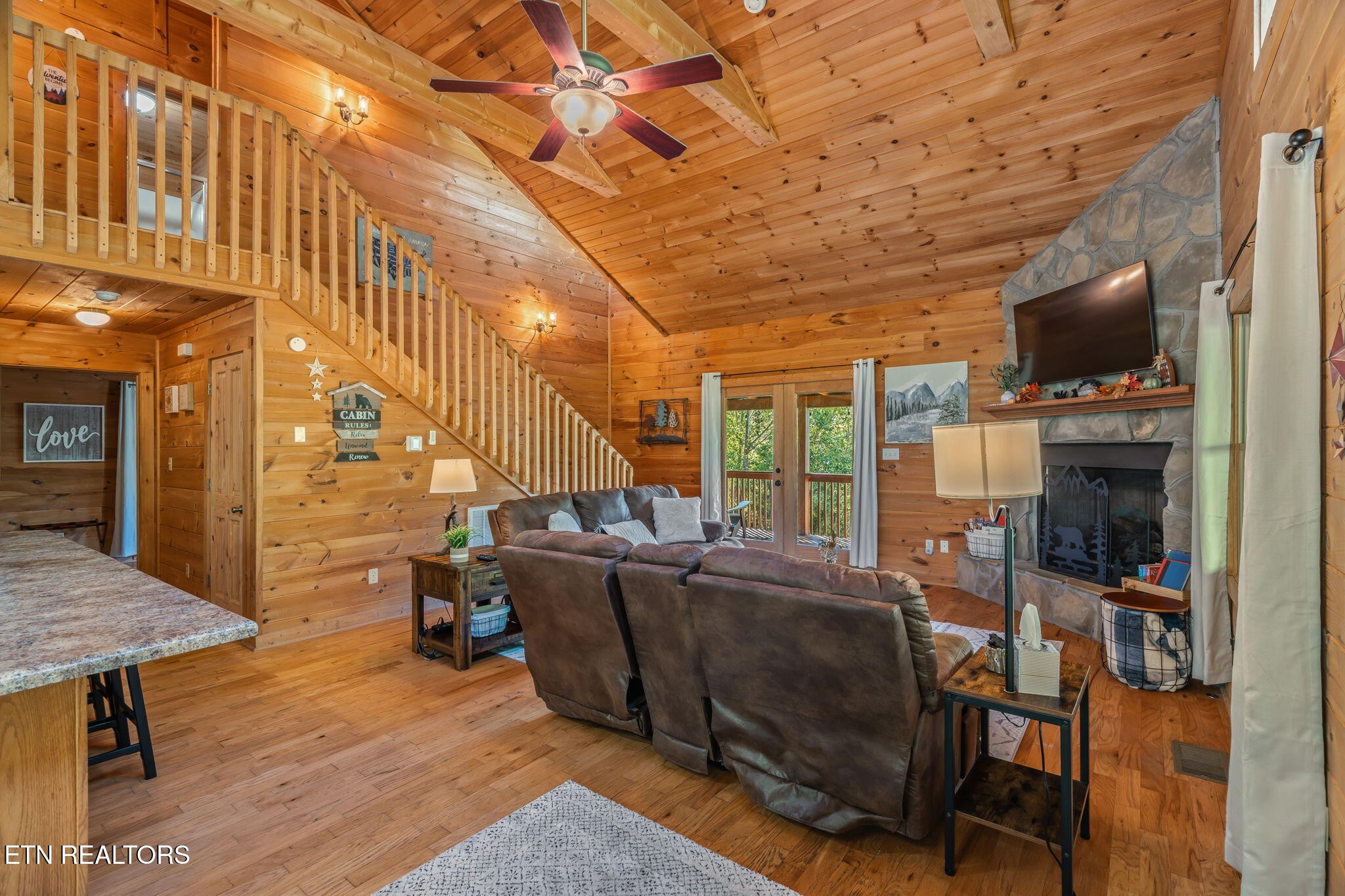 1723 Springer Road Sevierville, TN 37862 - Photo 15 of 43 a living room with furniture a flat screen tv and floor to ceiling window