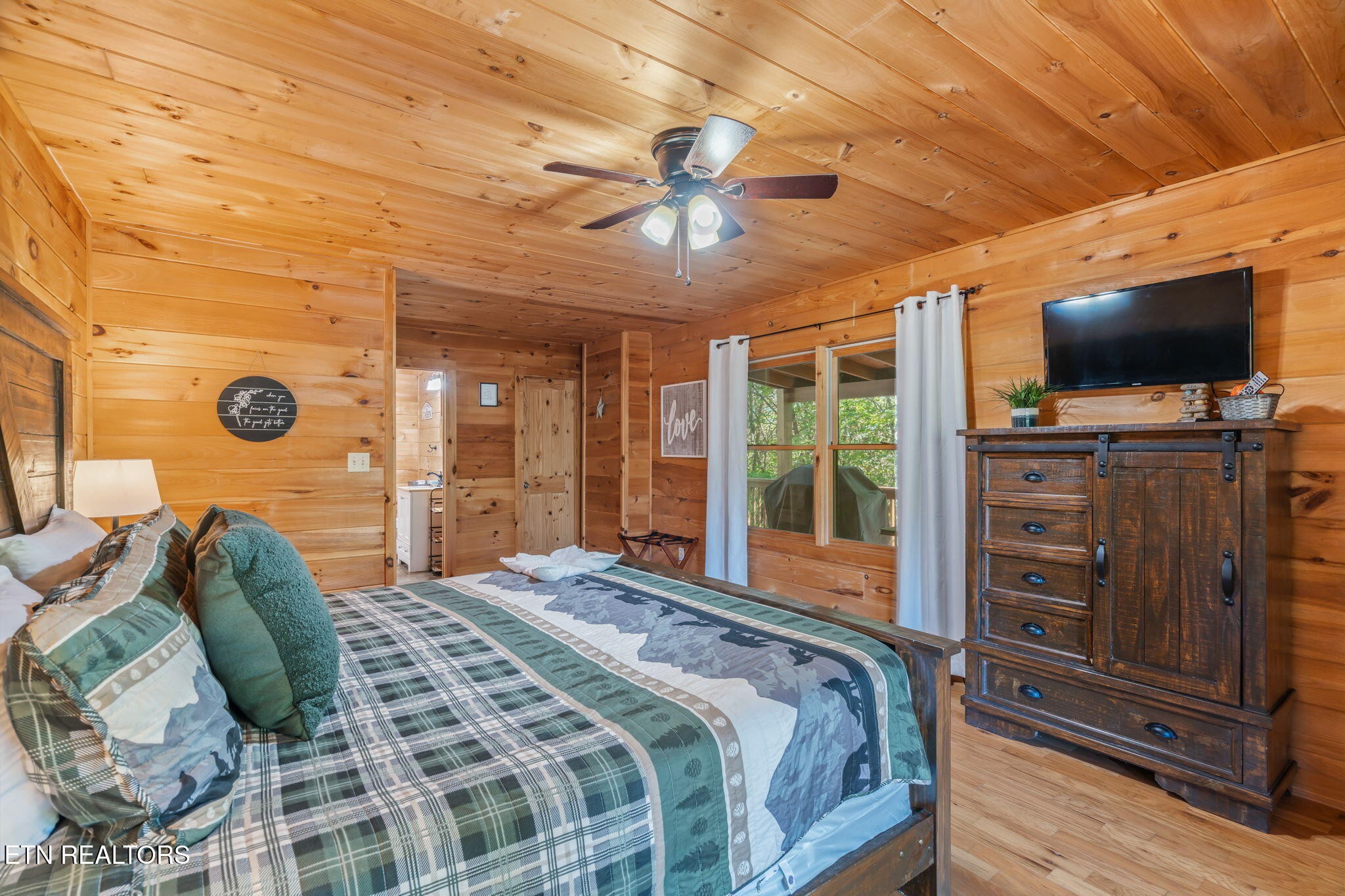1723 Springer Road Sevierville, TN 37862 - Photo 28 of 43 a bedroom with a large bed and a flat tv screen