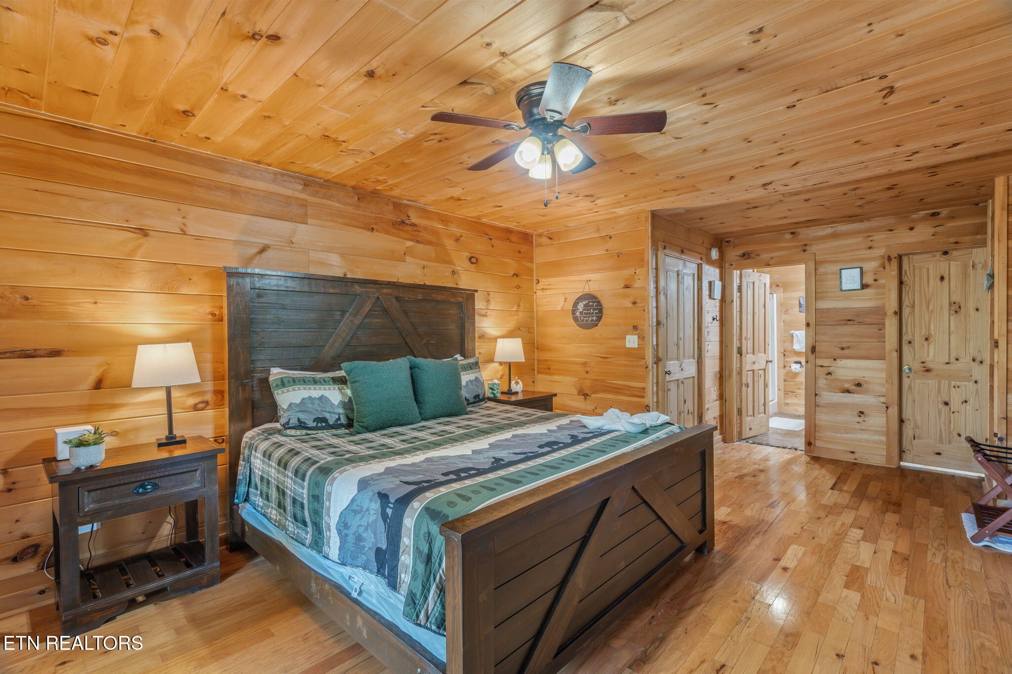1723 Springer Road Sevierville, TN 37862 - Photo 29 of 43 a bedroom with a bed and a chandelier