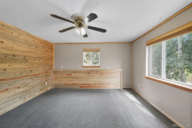 a living room with furniture tv and a window