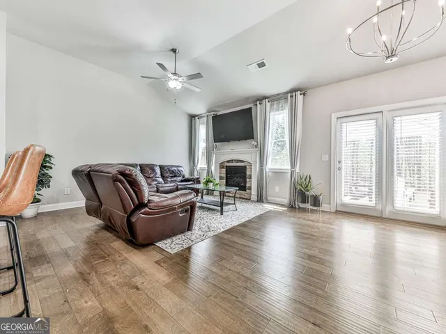 a living room with furniture a fireplace and a flat screen tv